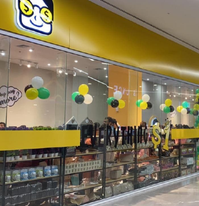 A Dollar Store shopfront, with the mascot sign and an “everything $1” window